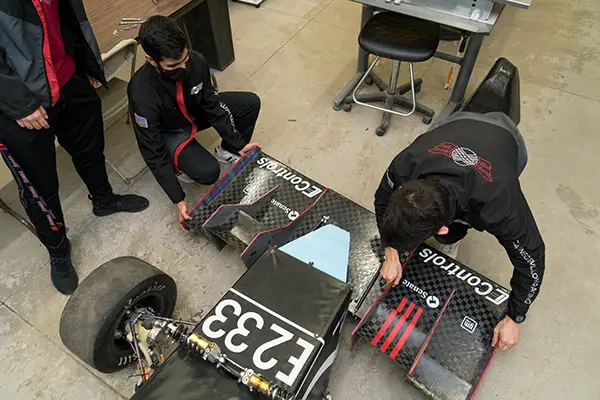 Students with a race car