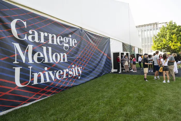 Large CMU Banner featured on outside of tent on the Cut