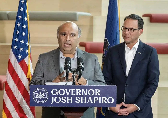 Rayid Ghani speaks next to Gov. Josh Shapiro