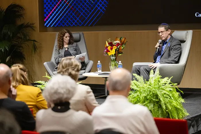 Michal Friedman and Rabbi Charlie Cytron-Walker seated on stage in front of audience