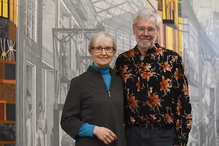 Stefani Danes and Doug Cooper standing in front of their mural