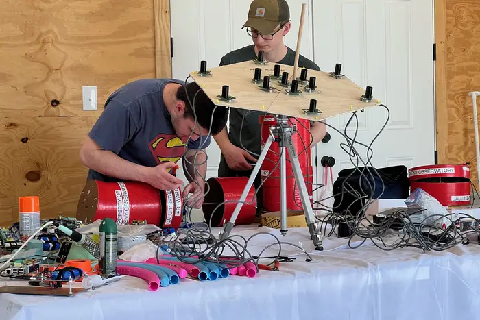 Norris Bach and another member of the Pitt Shadow Bandits work on attaching instrumentation to the balloon.