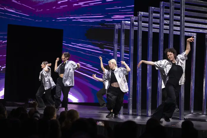 Lunar Gala dancers wearing sparkly silver jackets.