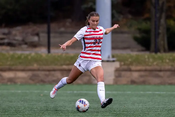 Breana Valentovish kicking soccer ball on field