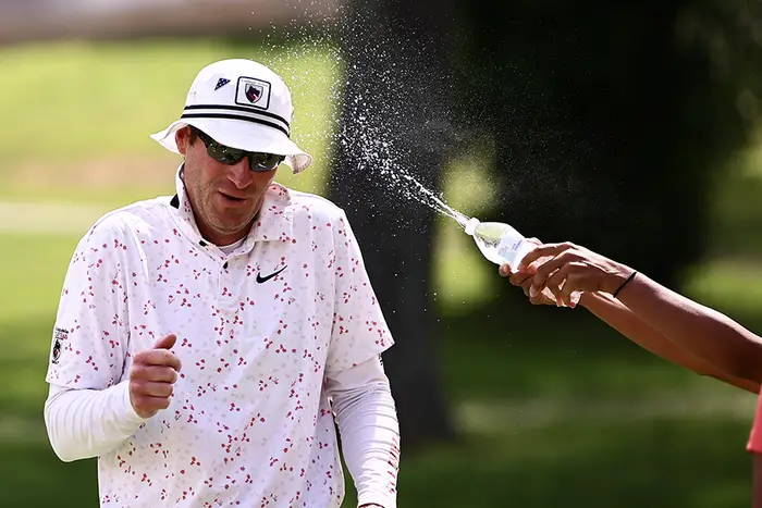 Coach Dan Rodgers gets sprayed with water.