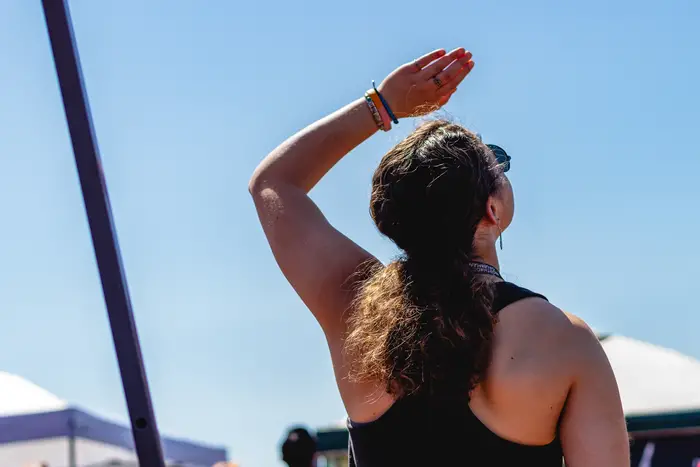 back of girl looking up at blue sky