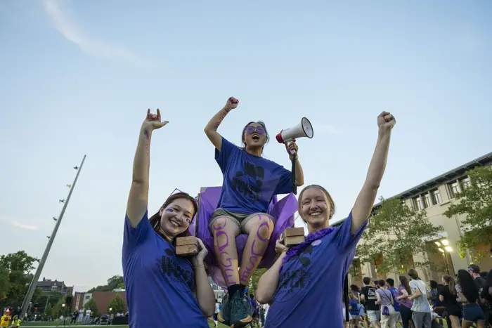 Students lift one of their own in a chair during the Carnegie Cup.