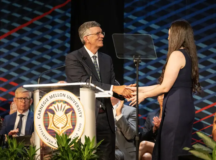 Provost James H. Garrett Jr. shakes the hand of Francesca Cain, president of the Undergraduate Student Senate.