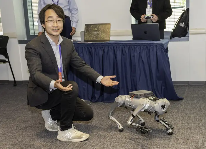 Ding Zhao poses with robot