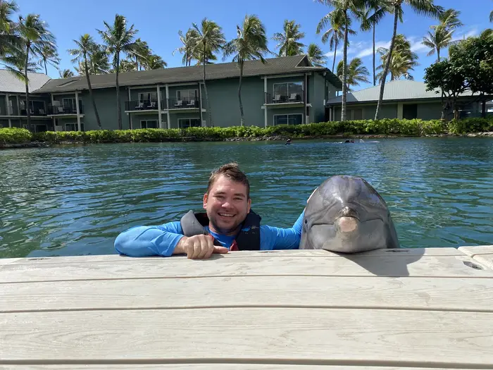 Alexander Ruesch poses with a dolphin