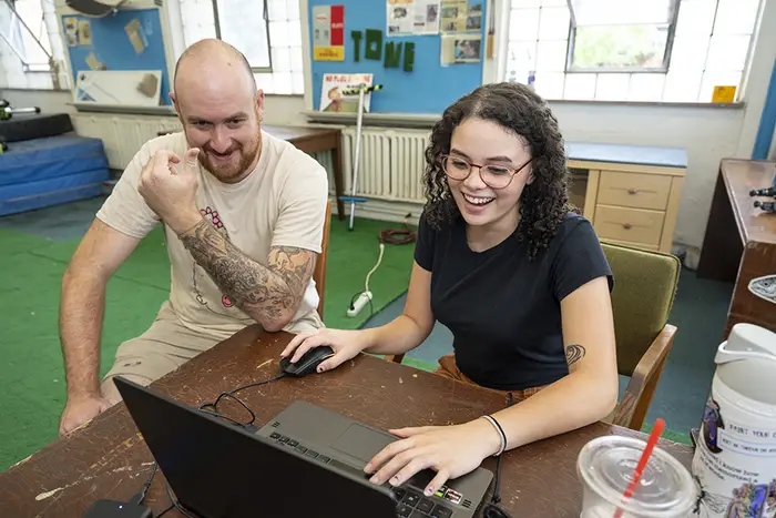 Will Weiner and Zoë Brown looking at laptop