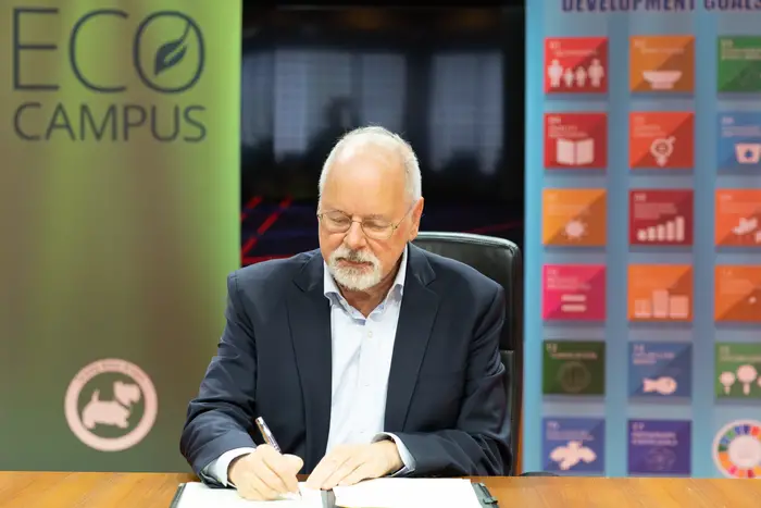 Michael Trick, Dean of Carnegie Mellon University in Qatar, signs a sustainability charter on Earth Day 2024 on behalf of the campus community..