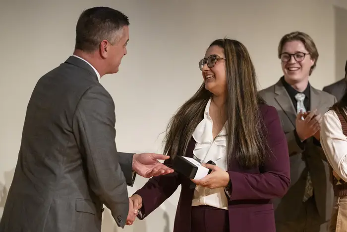 Tysen Kendig shakes hands with Huda Usman