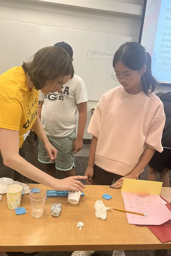 Krause shows ceramics experiment to young girl