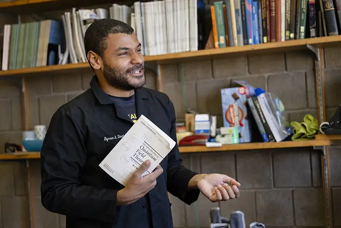 Byron Daniel holds a physics book