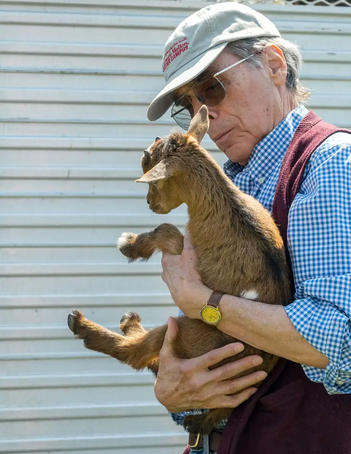 Russell Walker holds a small goat.