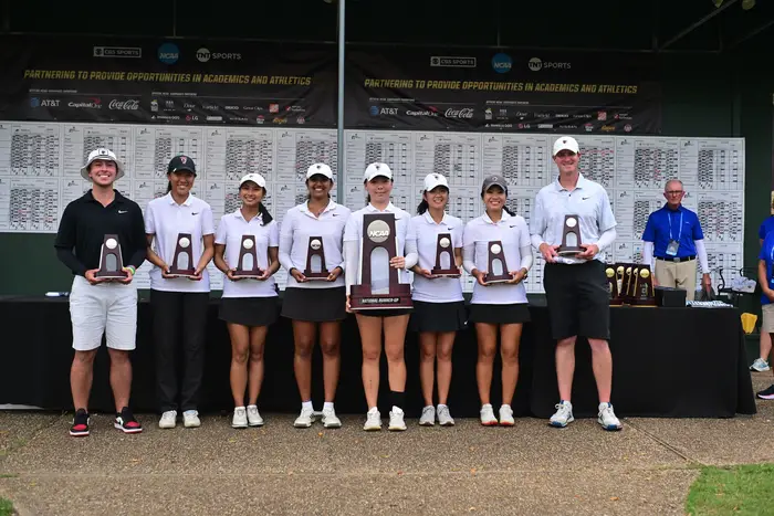 A group photo of the winning team with their trophies.
