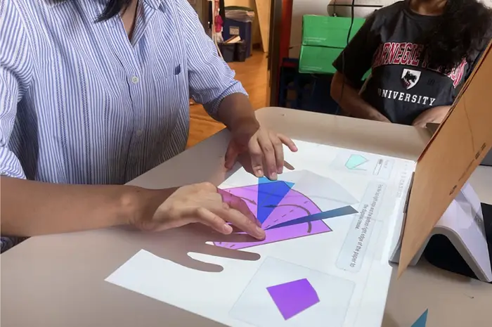 hands on table making origami