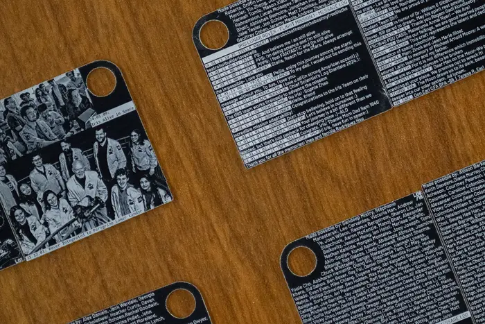 Etchings on small squares on a wood table.
