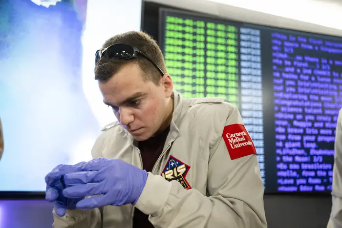 Zach Muraskin holds a piece of the payload.
