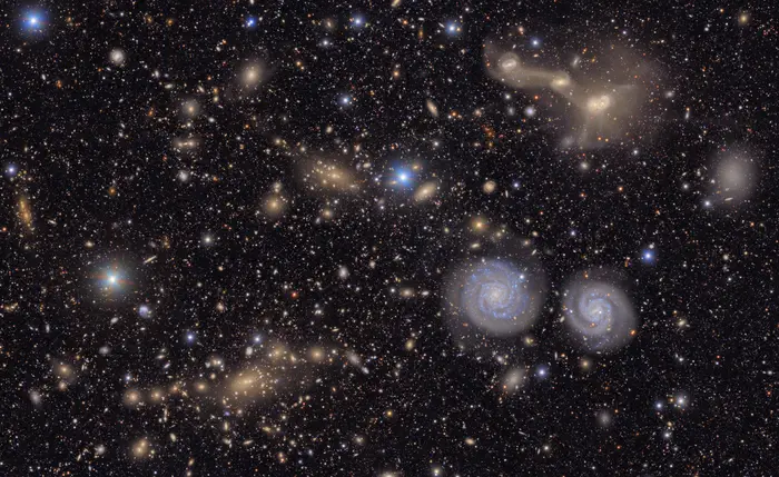 	Many stars and galaxies including two spiral galaxies and three merging galaxies.