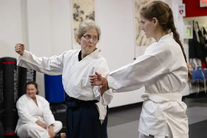 Barbara Litt, left, instructs a student in aikido.