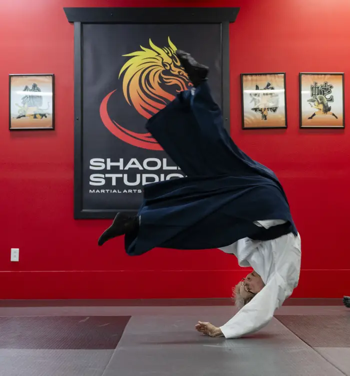 Barbara Litt flips on a mat. 