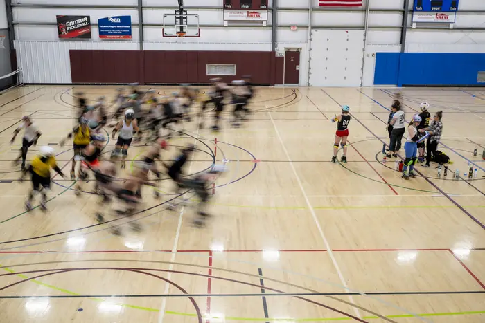A blurred motion photo of a roller derby match.