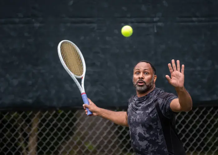 David Major swings at a tennis ball.