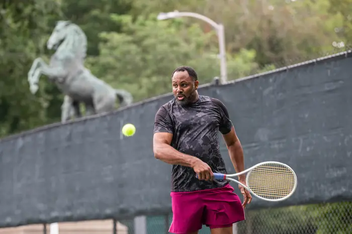 David Major returns a tennis serve. 