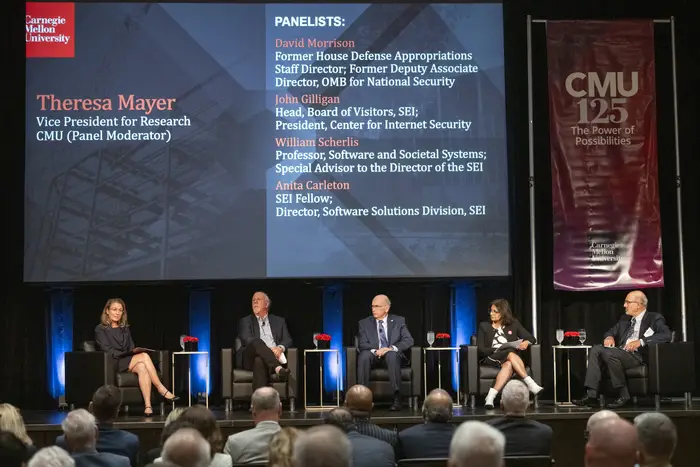 Theresa Mayer hosts a panel.