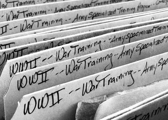 A box of folders, each labeled: WWII - training.