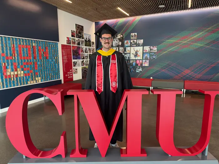 Erick Cohen stands in the Tepper Building following his graduation from CMU in 2025.