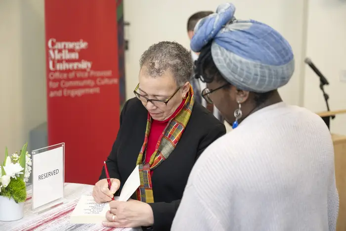 Beverly Daniel Tatum signs a book during a meet and greet.