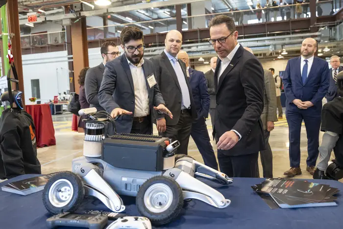 Gov. Josh Shapiro examines a robot during the grand opening of the Robotics Innovation Center on February 27, 2026, in Hazelwood.