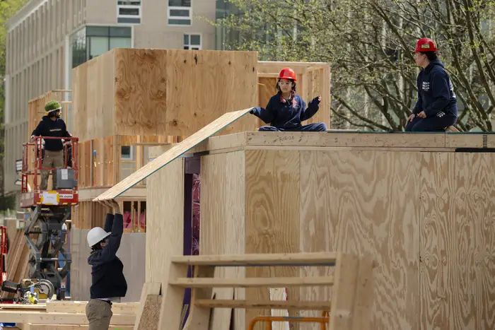 Students construct large wooden Booths at CMU. 