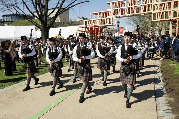 The Pipes and Drums band marches through campus. 
