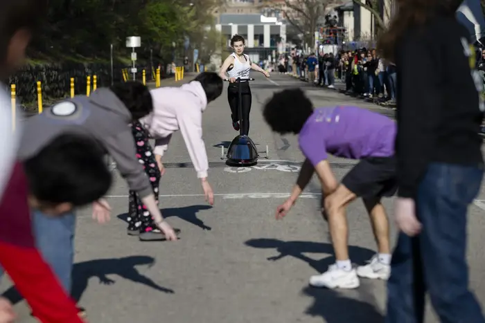 Students push a Buggy across the finish line. 