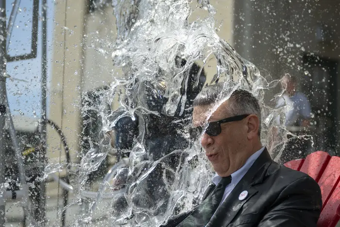 A dean gets doused in water. 
