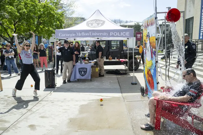 A contestant cheers after dousing a dean. 
