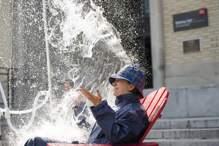 A dean gets doused in water. 