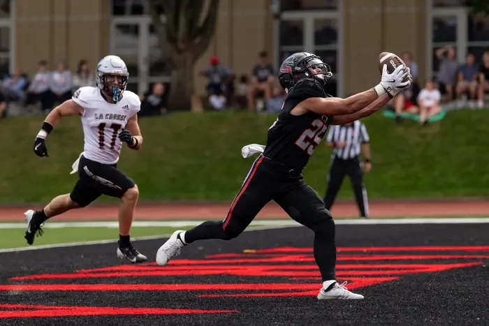 A CMU football player extends for a catch in the end zone. 