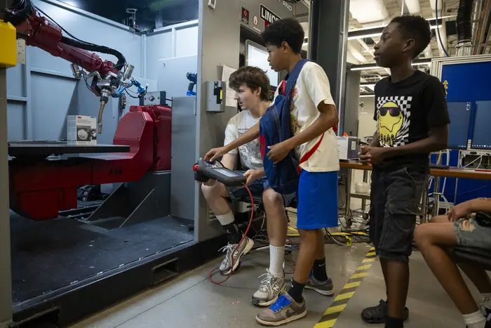 three students steering a robot