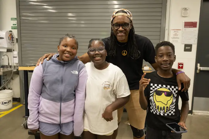 Pastor Tim Smith with three students