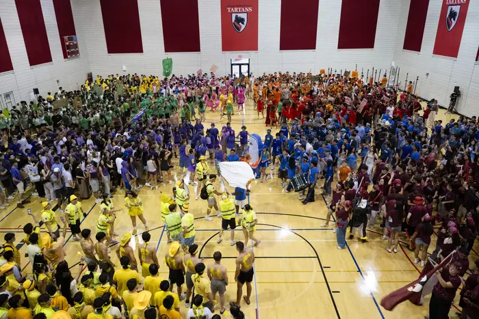 Students gather in their house colors in a gym for Carnegie Cup.