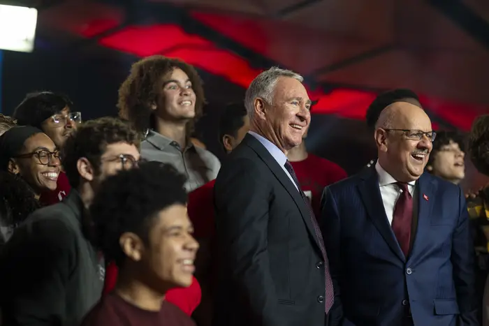 Ken Griffin stands with Farnam Jahanian at a town hall surrounded by the CMU community. 