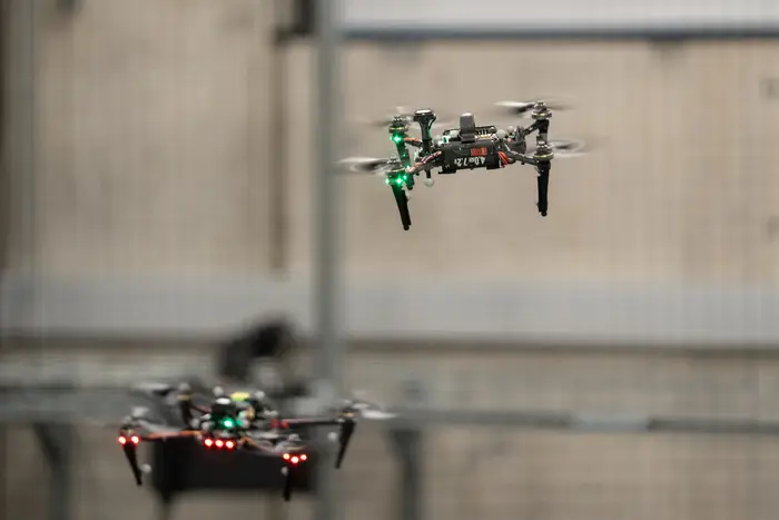 Autonomous drones navigate around one another during an AirLab demo at the Robotics Innovation Center.
