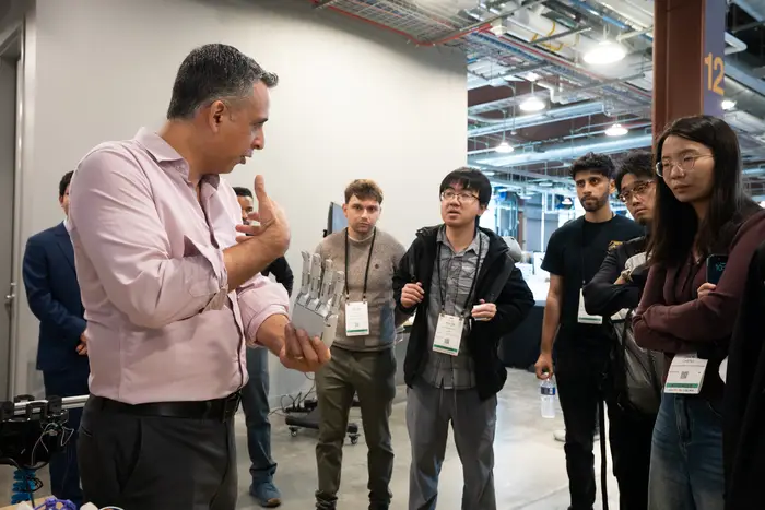 Carmel Majidi, Clarence H. Adamson Professor of Mechanical Engineering, gives visitors a demonstration of a robotic hand as part of a demonstration for the Soft Machines Lab.