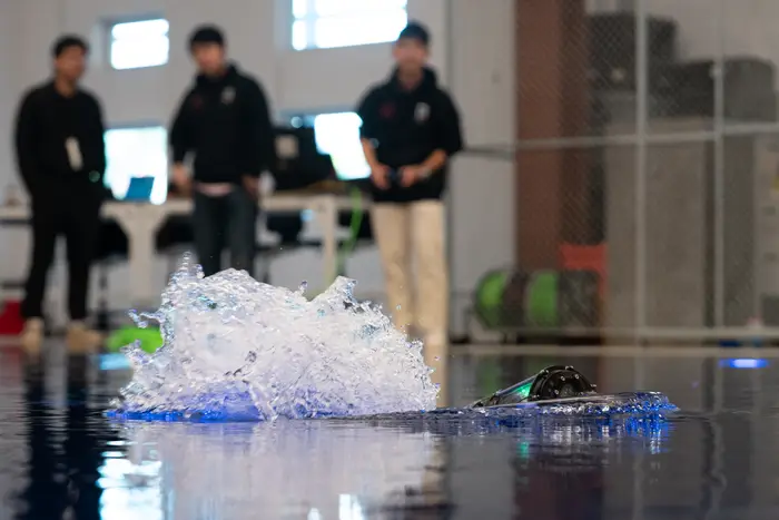 The Biorobotics team gives a demonstration of an aquatic snake robot in the Robotics Innovation Center’s wet lab.