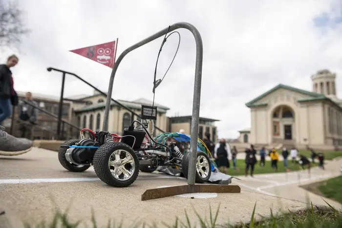 small robot rolls through a gate